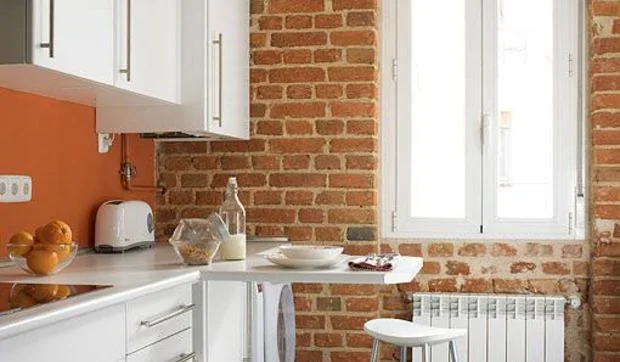 Una cocina con pared de ladrillo visto